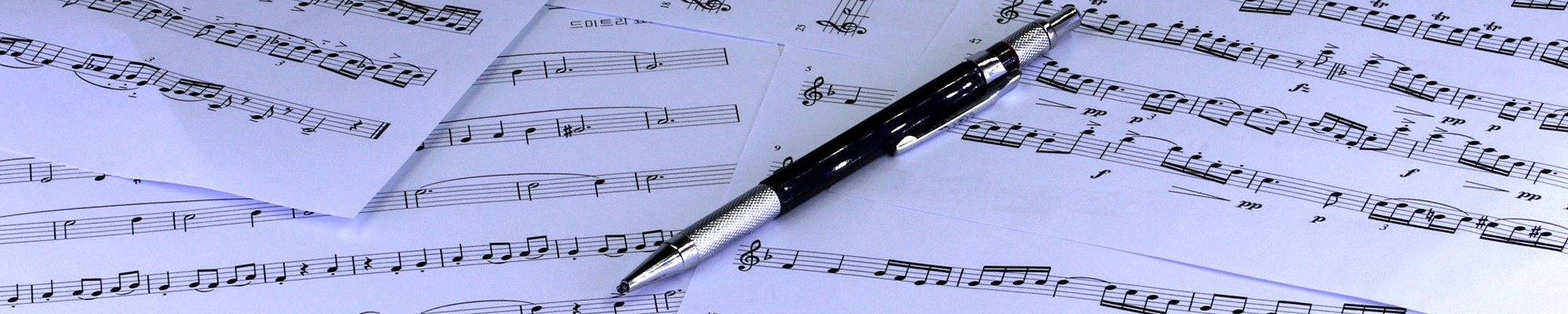 sheets of music and pen